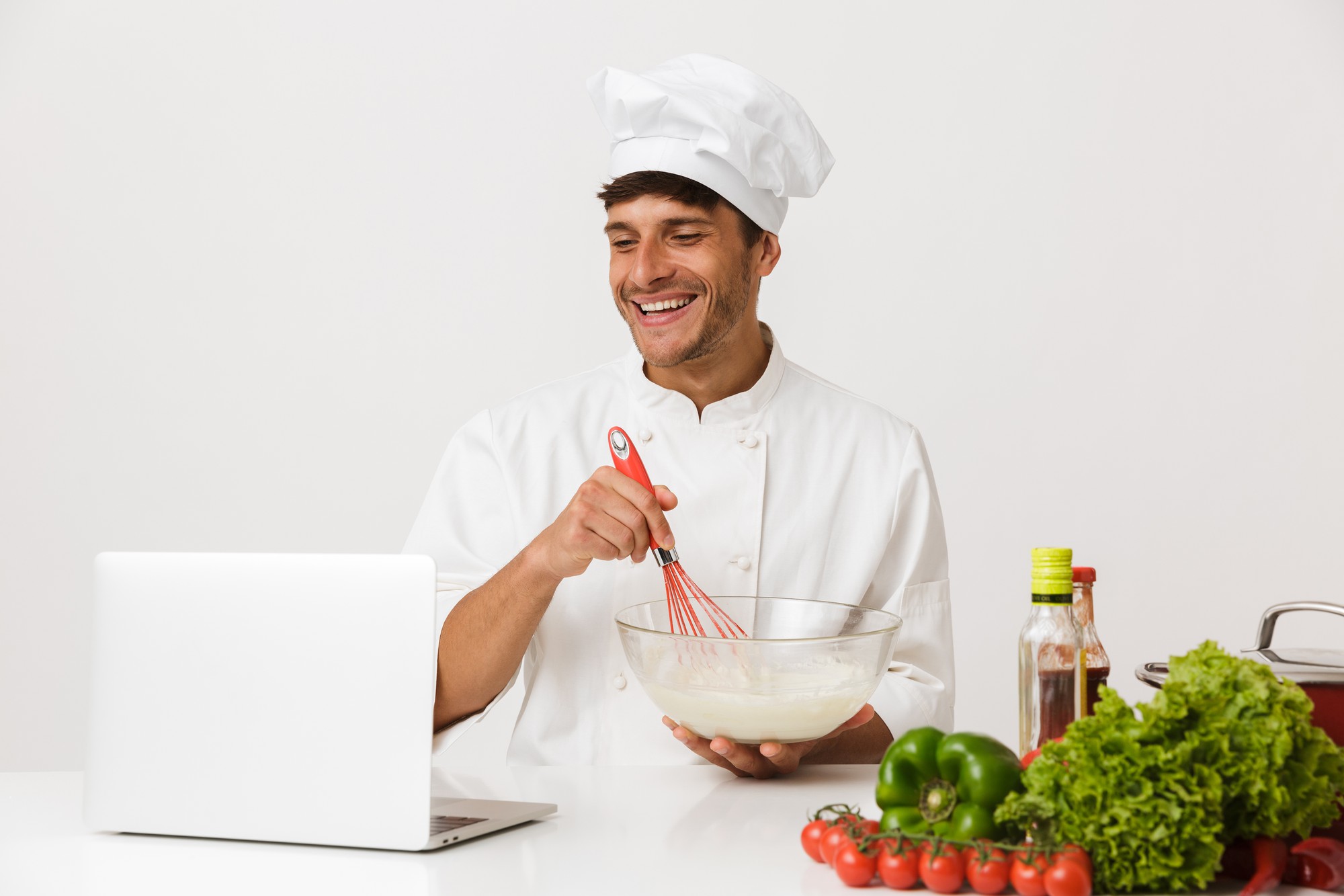 Chef smiling during online class in modern kitchen