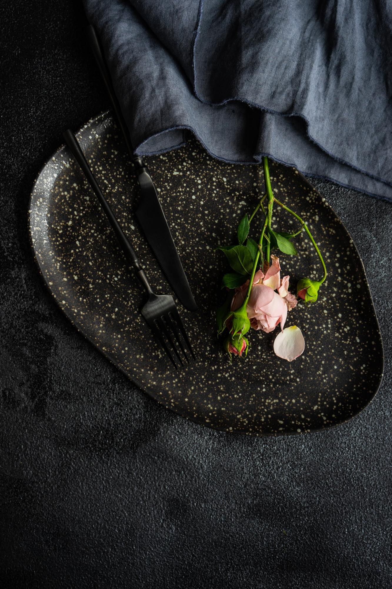Selection of plated courses on dark table with elegant plating